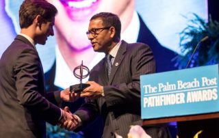 Robert Linck of Oxbridge Academy accepts the $4,000 scholarship for Academic Excellence from Patrick Franklin at the 35th annual Pathfinder Scholarship Awards. (Allen Eyestone / The Palm Beach Post)
